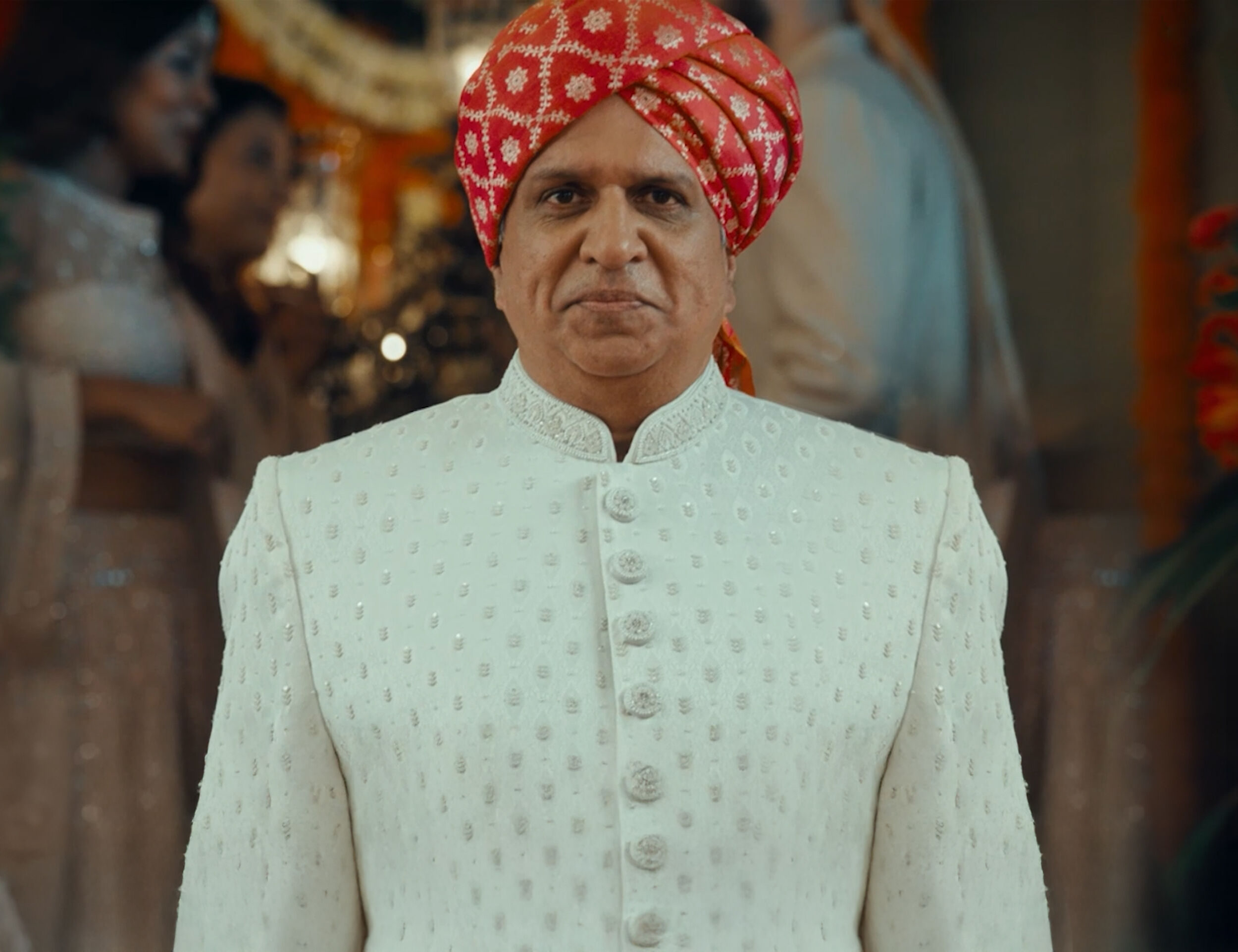 Father dressed in a classic white kurta paired with a red safa, perfect for pre-wedding celebrations.